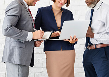 Stock image of three working professionals collaborating on a project