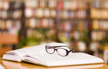 glasses on book in library