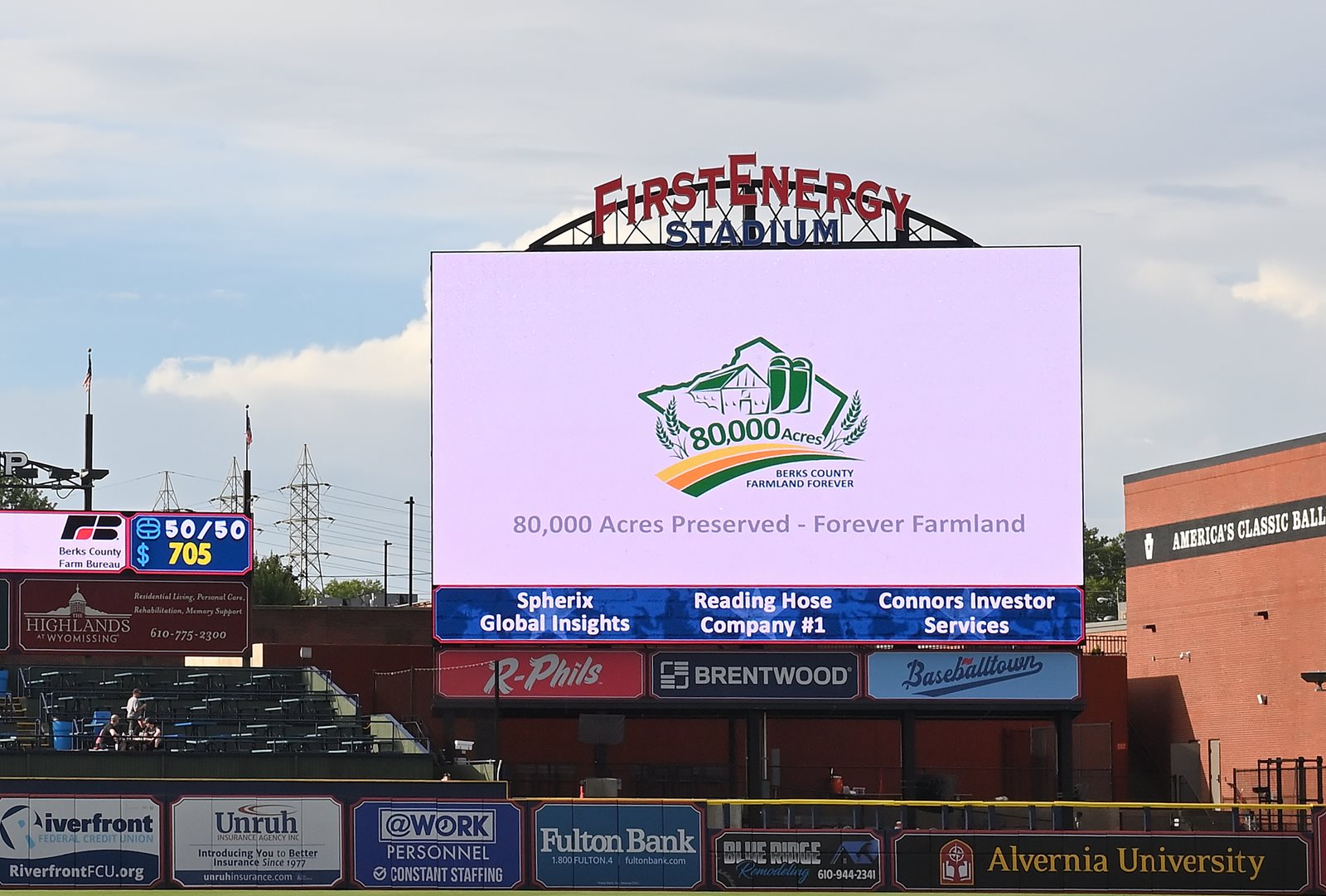 80,000 Acre Celebration -post baseball stadium with 80,000 Acre logo on screen