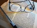 Open book glasses and pen